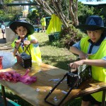 Students use iron moulds to squeeze the water out of the paper bricks.